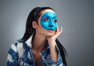 Buy stock photo Studio shot of a beautiful young woman looking thoughtful while posing against a grey background