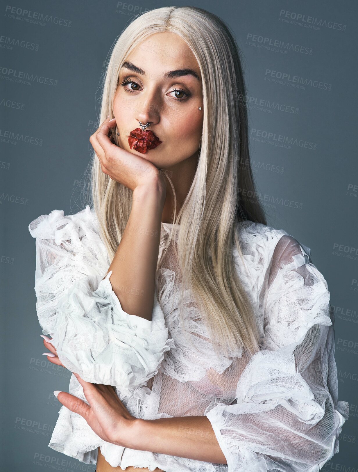 Buy stock photo Portrait of an attractive young woman displaying her tattoos with a grey background