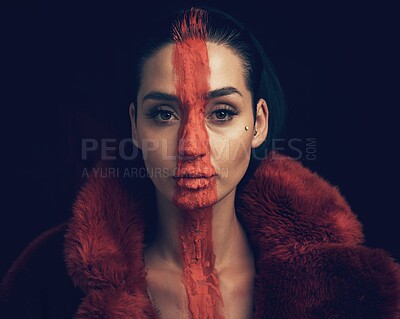 Buy stock photo Studio shot of a young woman posing with paint on her face on a black background