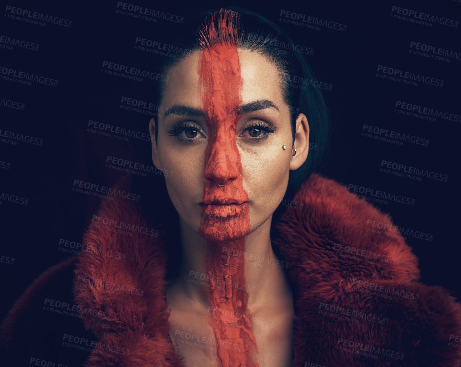 Buy stock photo Studio shot of a young woman posing with paint on her face on a black background