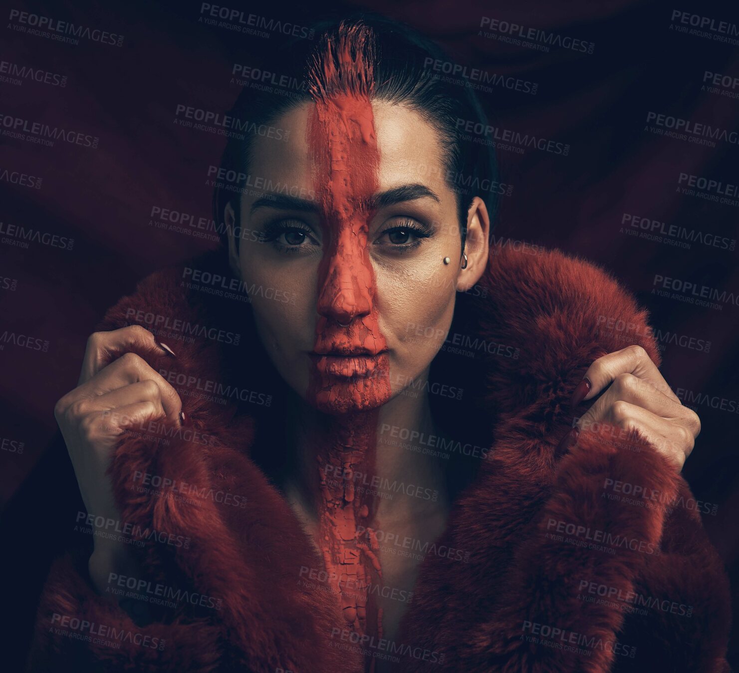 Buy stock photo Studio shot of a young woman posing with paint on her face on a black background