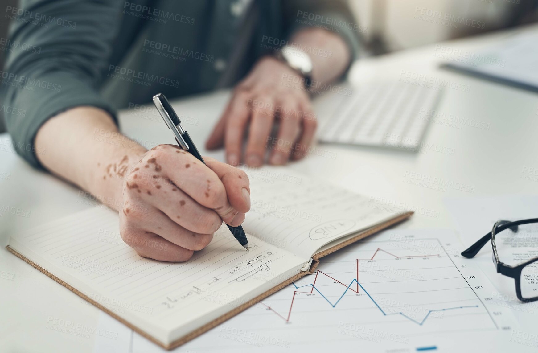 Buy stock photo Sot of an unrecognizable man writing in a book at work