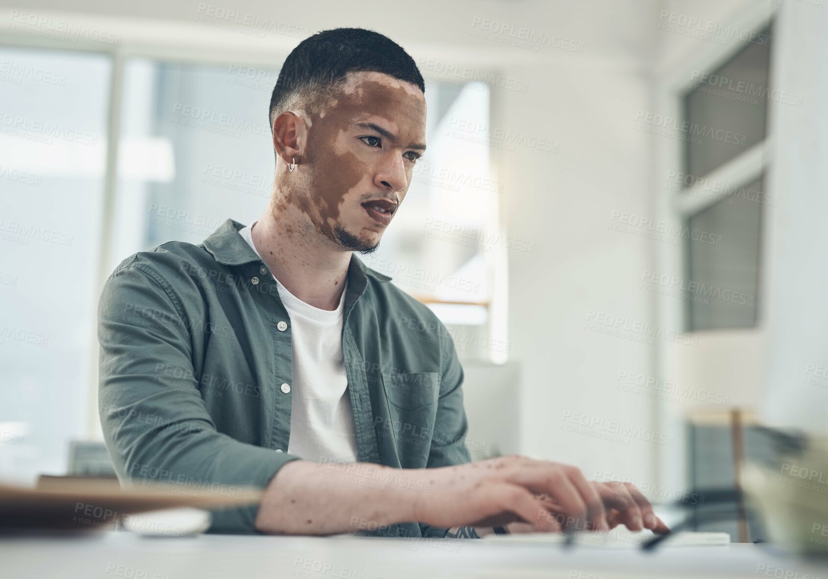 Buy stock photo Shot of a young business man working in a modern office