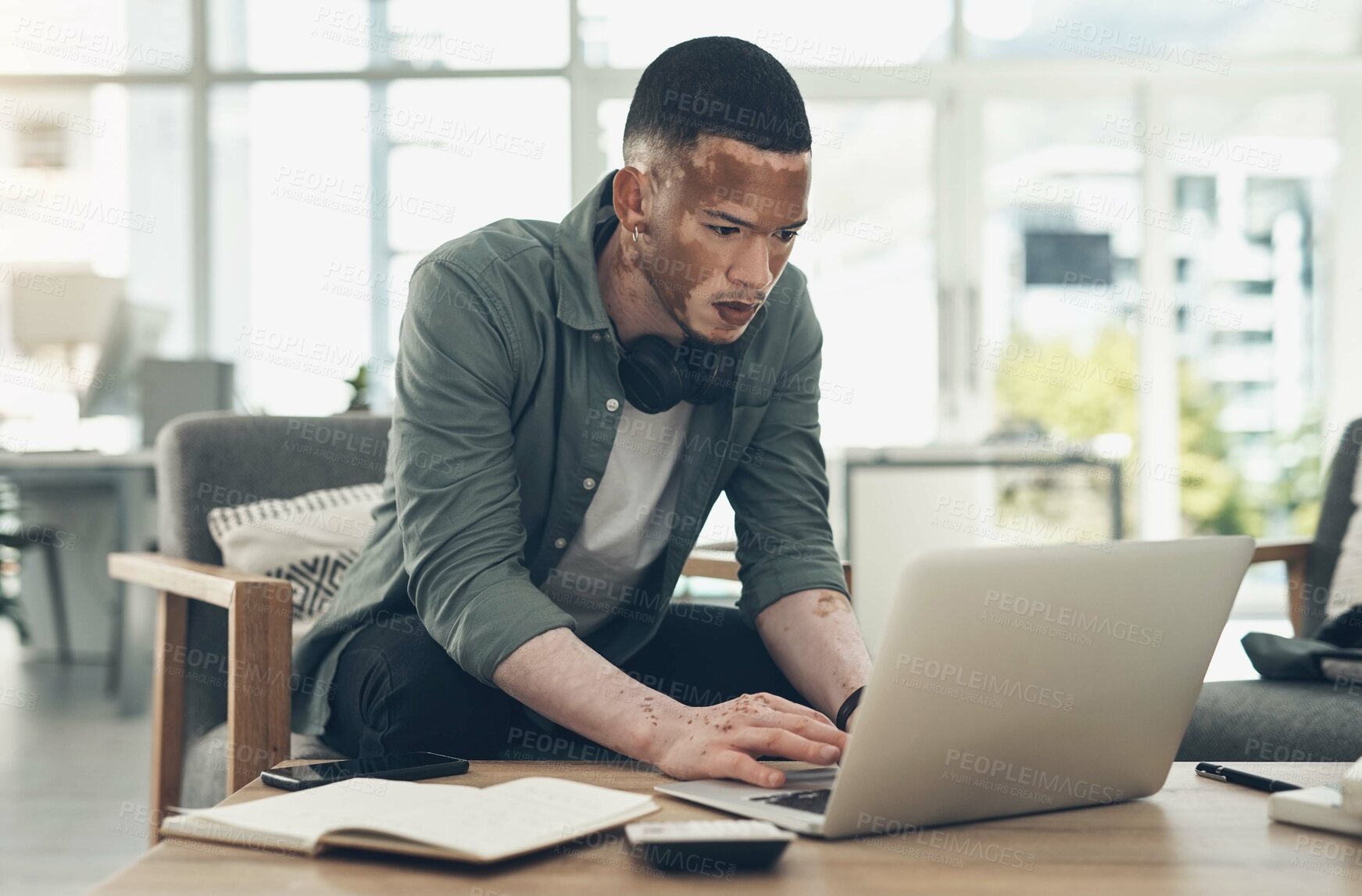 Buy stock photo Shot of a young business man working in a modern office