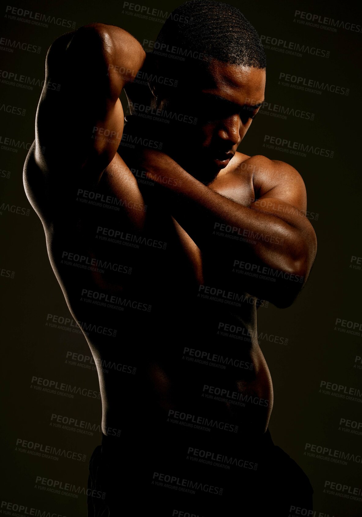 Buy stock photo Studio shot of a fit young man posing against a black background