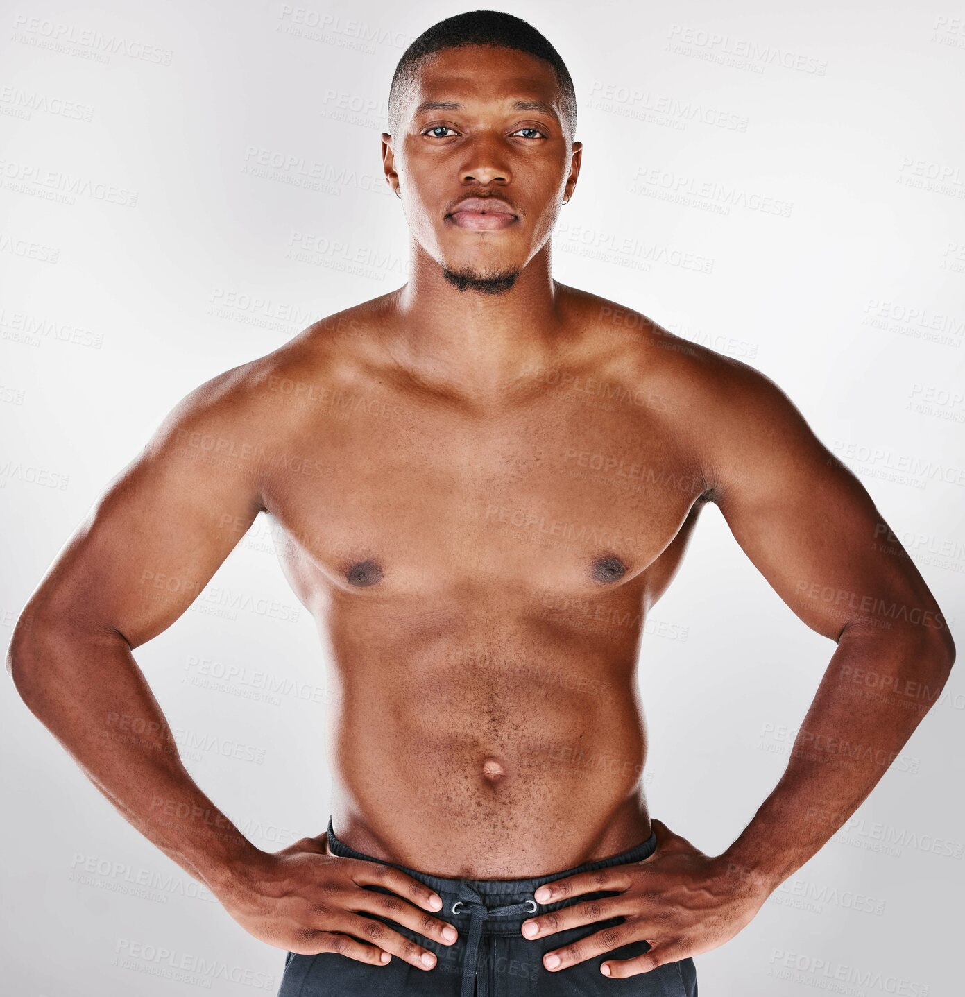 Buy stock photo Studio portrait of a shirtless handsome young man posing against a white background