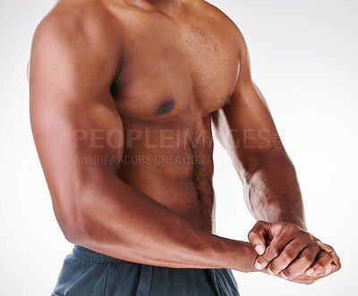 Buy stock photo Cropped studio shot of a shirtless muscular man posing against a white background