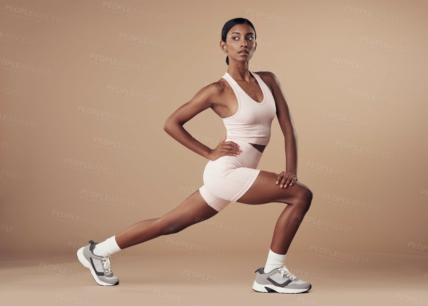 Buy stock photo Full length shot of an attractive young woman working out in the studio and holding a lunge position