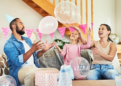 Buy stock photo Shot of a little girl celebrating a birthday with her parents at home