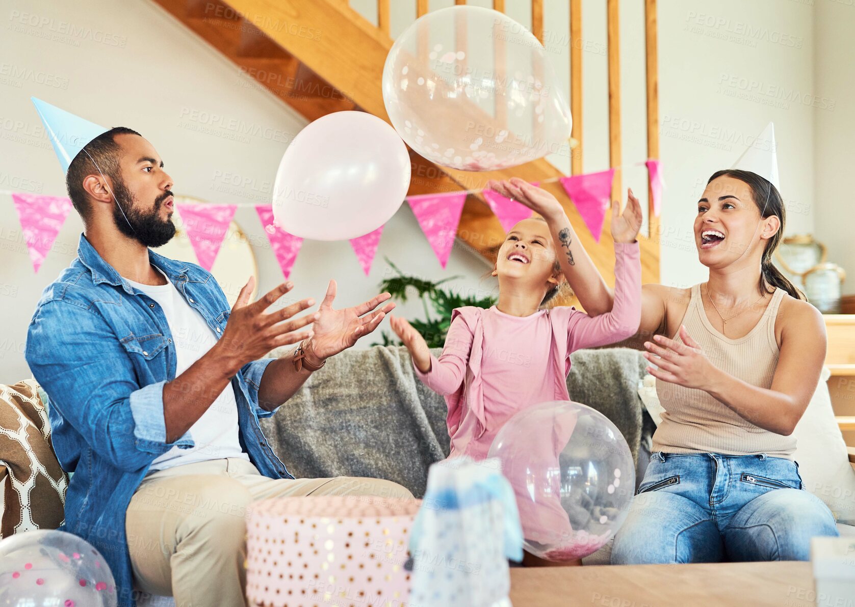 Buy stock photo Shot of a little girl celebrating a birthday with her parents at home