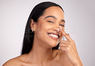 Buy stock photo Happy woman, portrait smile and cream on nose for skincare cosmetics against a grey studio background. Face of female person smiling with beauty lotion, SPF or moisturizing creme for facial treatment