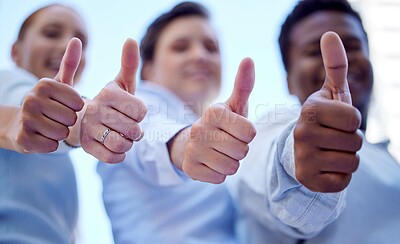 Buy stock photo Low angle shot of three unrecognizable businesspeople giving thumbs up to the camera while standing outside