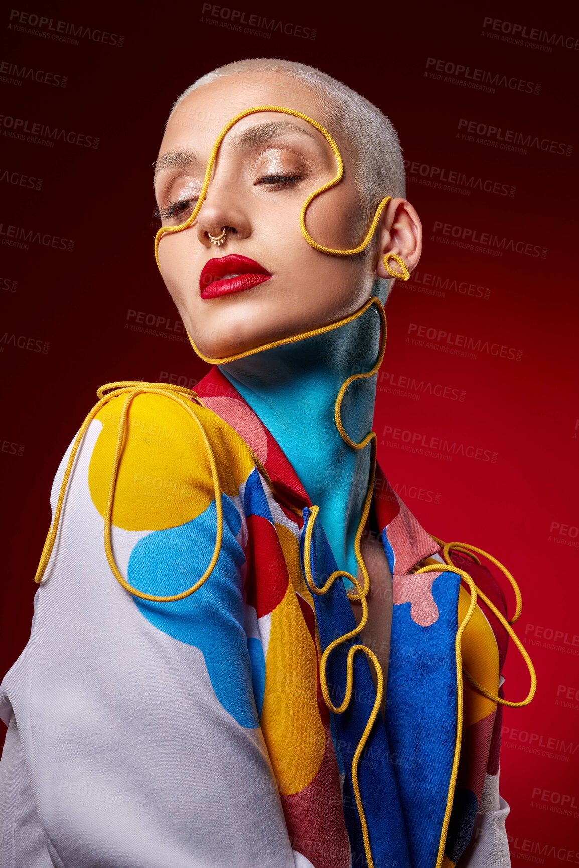 Buy stock photo Studio shot of a stylish young woman posing against a red background