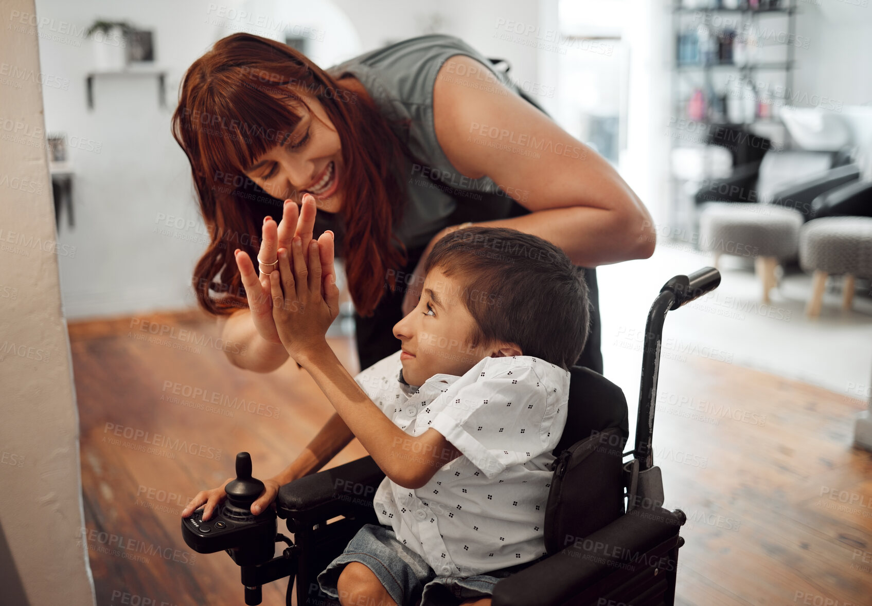 Buy stock photo Hairdresser, high five and child in hair salon happy with hair cut or hairstyle. Kid with a disability in wheelchair, stylist and success smile. Support, happiness or care for boy with cerebral palsy