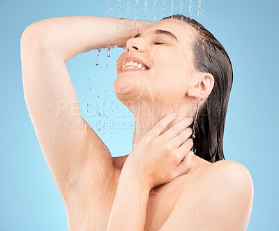 Buy stock photo Skincare, shower and woman with water in studio on blue background for washing, cleaning and hygiene. Spa, hydration and girl with stream, drops and water splash for body care, wellness and health