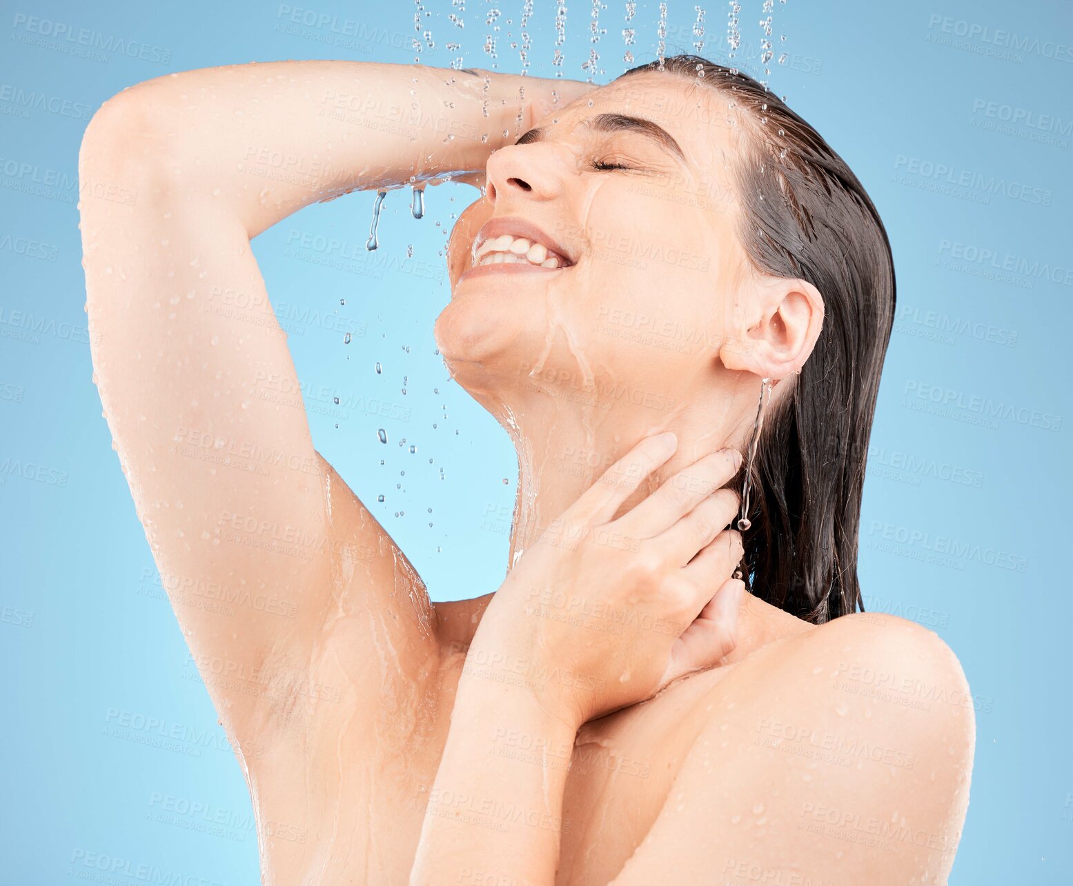 Buy stock photo Skincare, shower and woman with water in studio on blue background for washing, cleaning and hygiene. Spa, hydration and girl with stream, drops and water splash for body care, wellness and health