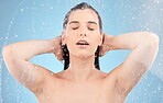 Water, woman and body shower on blue background for healthy skincare, beauty and wellness. Young studio model, water splash and washing hair for personal hygiene, self care and cleaning in bathroom 