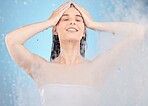 Hair, cleaning and water splash with woman in a shower for hygiene, grooming and wellness on blue background. Hair care, beauty and woman in a bathroom for washing, body care and shampoo product