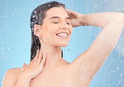 Buy stock photo Woman, shower and cleaning for hygiene, bodycare and beauty with water on a blue studio background. Skincare, body care and female showering or washing and cleansing the skin in grooming routine