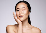Face portrait, beauty skincare and Asian woman in studio isolated on a gray background. Makeup, natural cosmetics and female model with glowing, healthy and flawless skin after spa facial treatment.