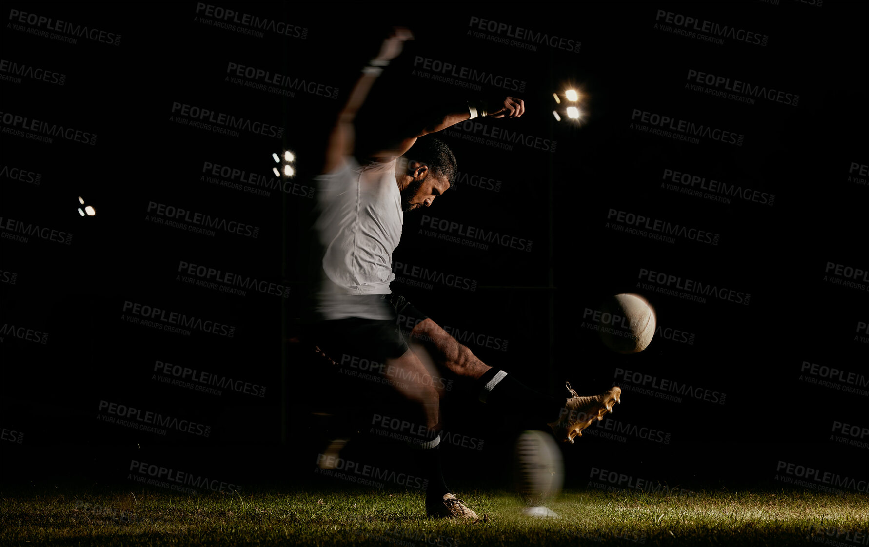 Buy stock photo Rugby, night and man kicking ball to score goal at dark stadium at game, match or practice workout. Sports, fitness and motion, player with blurred action on grass with energy and skill in team sport