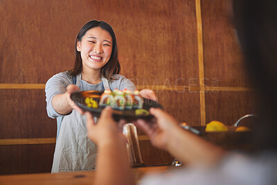 Sushi, restaurant worker and happy woman with smile from food and Asian meal in a kitchen. Plate, female waiter job or chef working with fish recipe for lunch order with cooking in Japanese bar