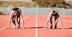 Woman, running and start in sports competition, race or fitness on outdoor stadium track together. Female person or people in preparation for run, marathon or sprint in team practice or training