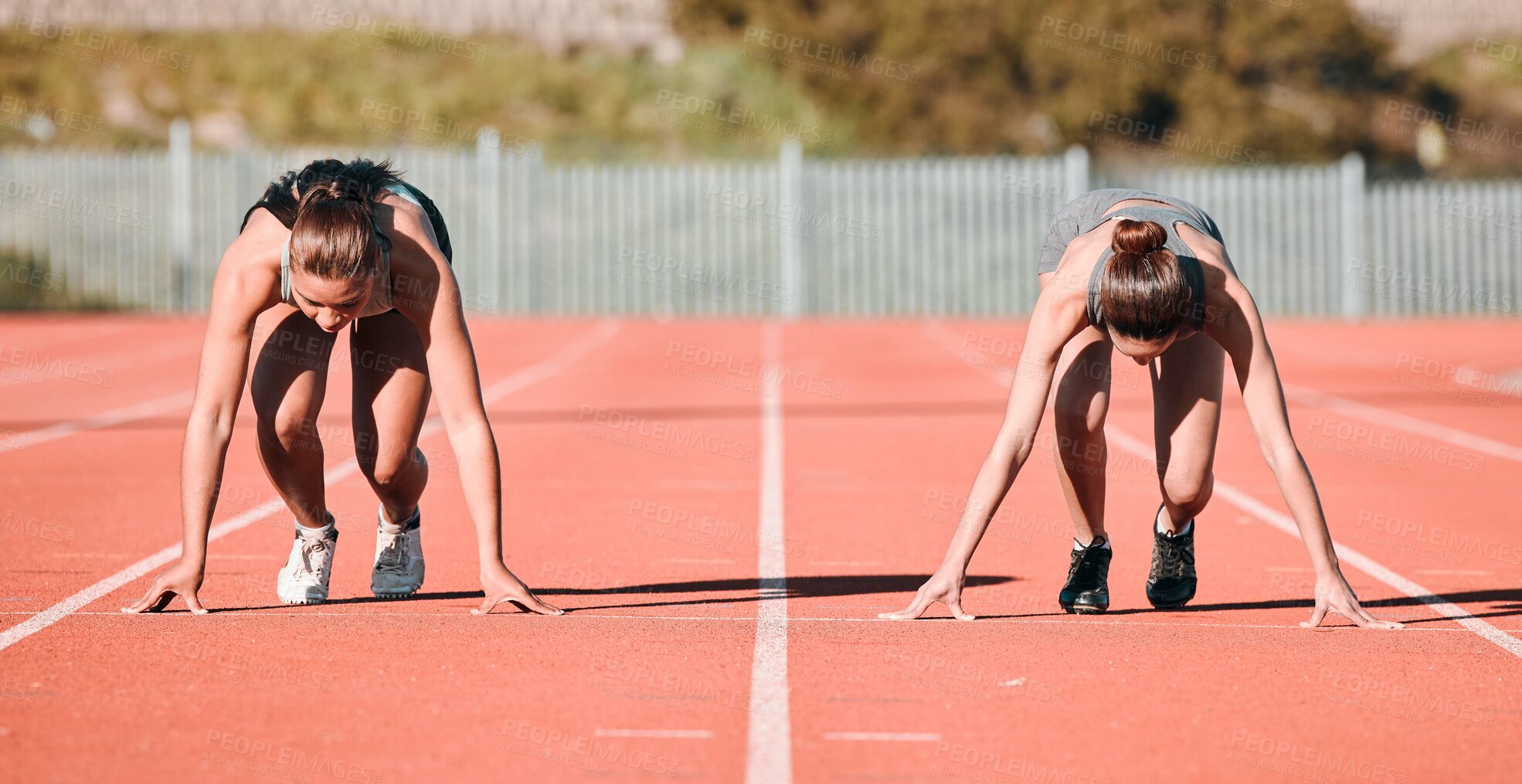 Buy stock photo Woman, running and start in sports competition, race or fitness on outdoor stadium track together. Female person or people in preparation for run, marathon or sprint in team practice or training