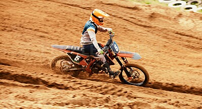 Motorcycle, dust and motion blur with a sports man on space in the desert for dirt biking. Bike, fitness and speed with a person driving on sand or off road course for freedom or performance