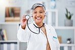 Doctor, woman and portrait with stethoscope for heartbeat, healthcare services or cardiology. Happy mature medical surgeon consulting with tools for listening, check breathing or test lungs in clinic