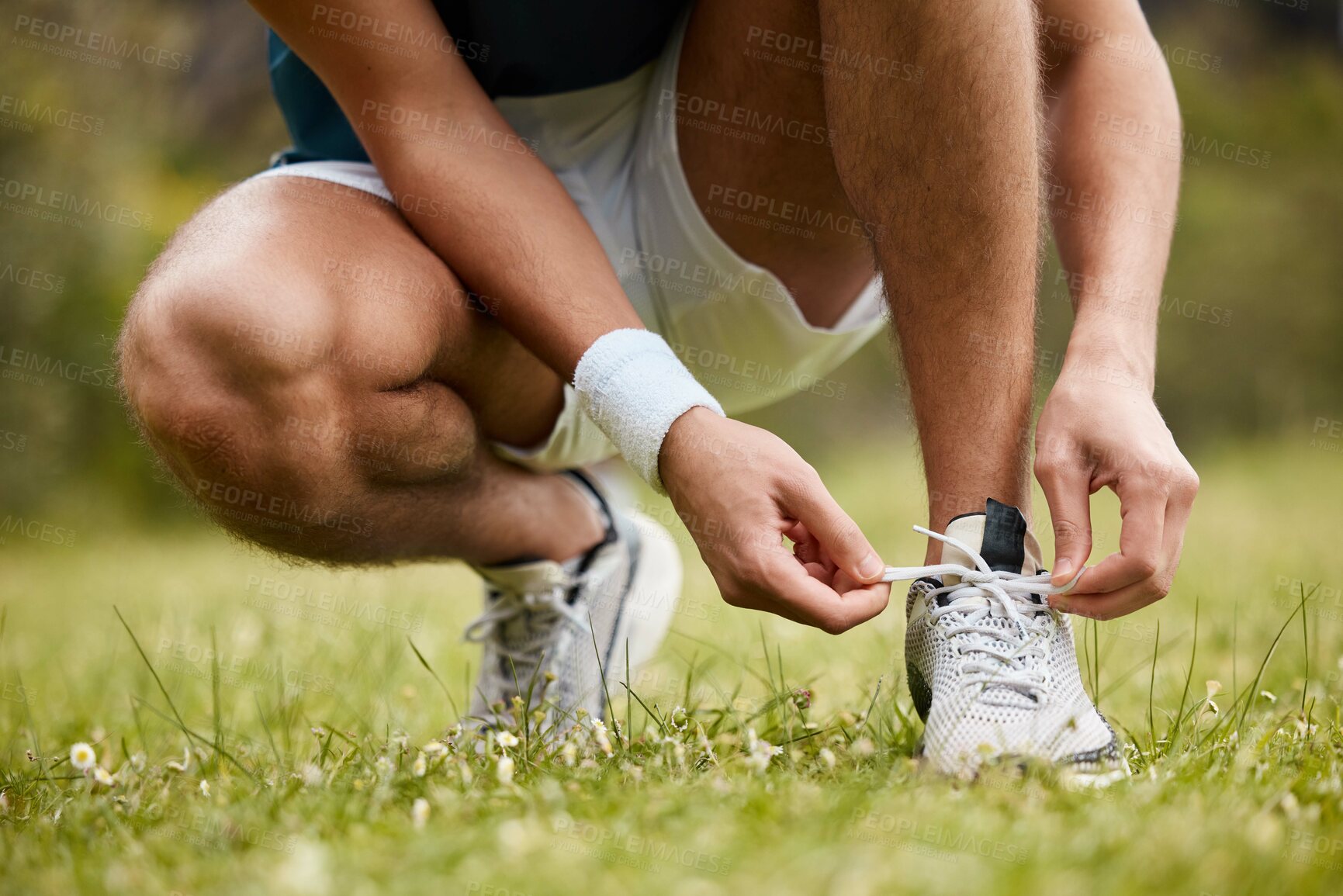 Buy stock photo Shoes, tie and a sports person getting ready for an exercise run closeup outdoor for cardio training. Fitness, hands or feet with an athlete at the start of his marathon on a field of grass in summer