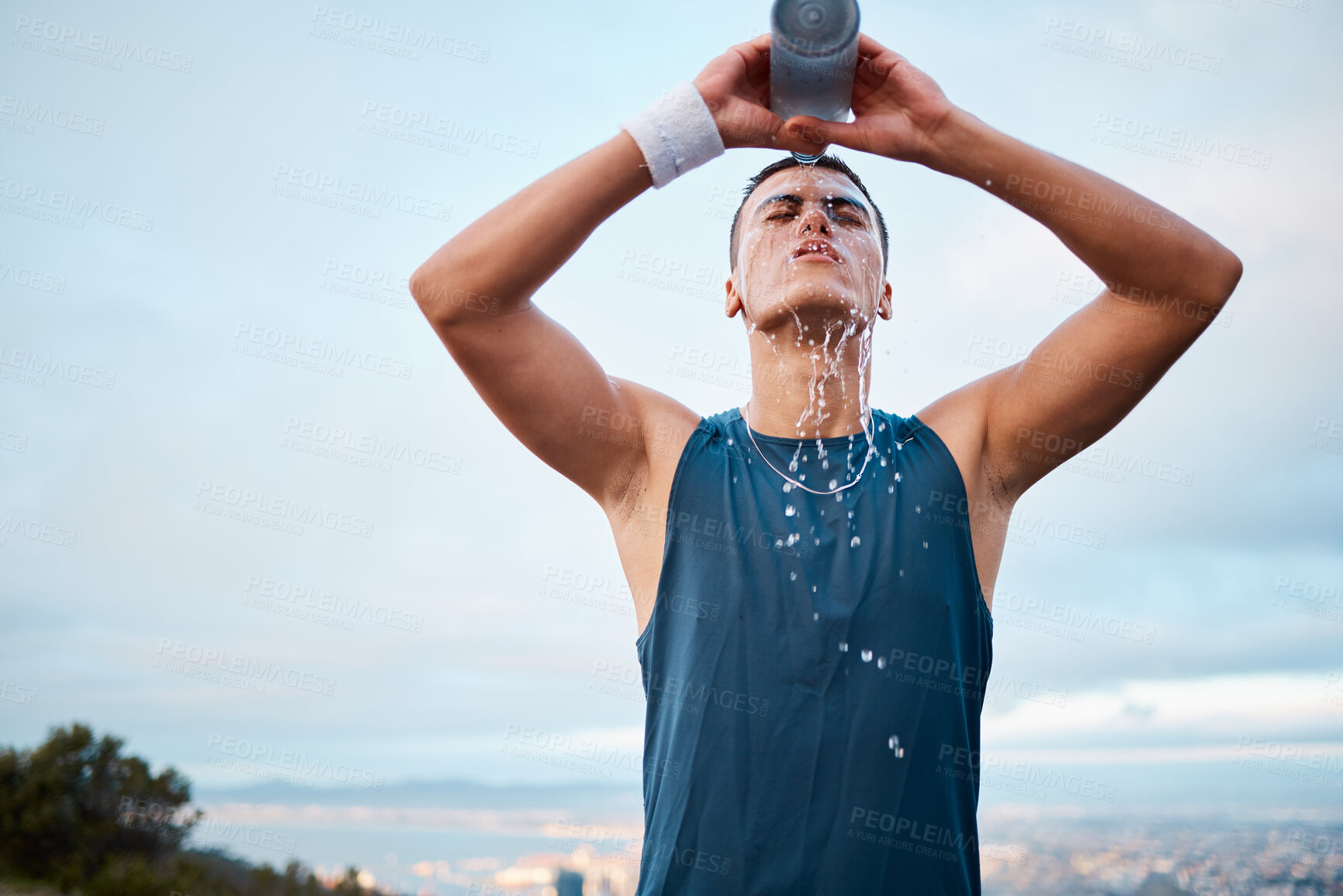 Buy stock photo Exercise, water and fatigue with a sports man outdoor, tired after running a marathon for cardio training. Fitness, health and an exhausted young runner pouring liquid for hydration or refreshment