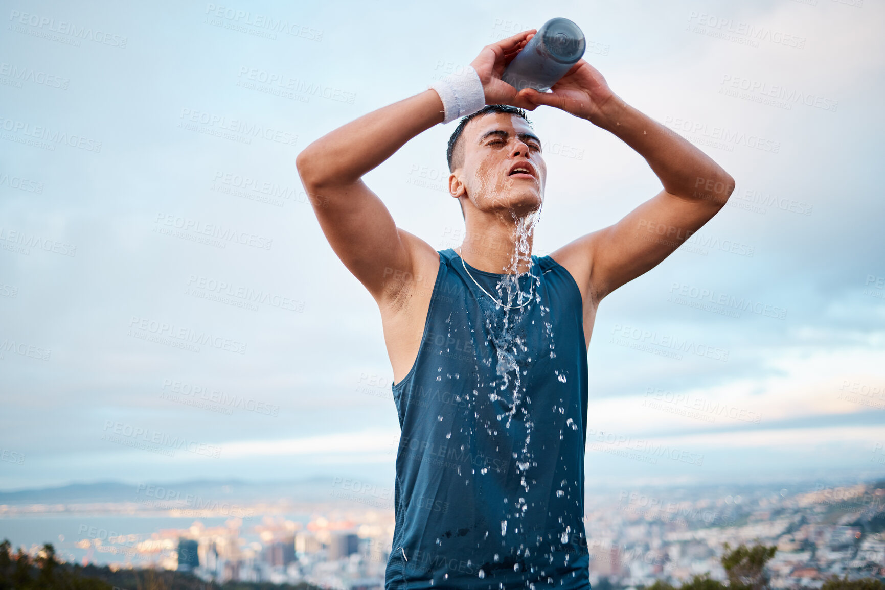 Buy stock photo Fitness, water and fatigue with a sports man outdoor, tired after running a marathon for cardio training. Exercise, health and an exhausted young runner pouring liquid for hydration or refreshment