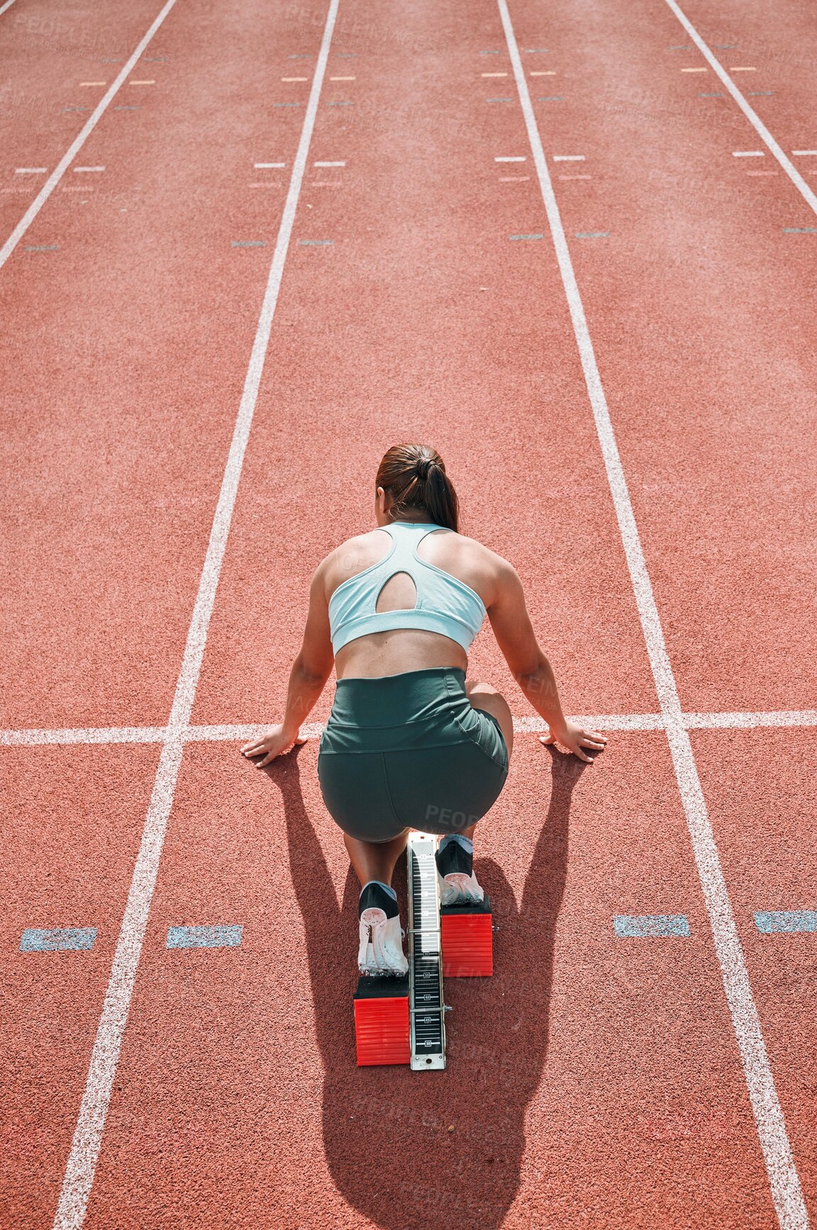 Buy stock photo Start, running and fast with woman on race track for sports, competition and marathon. Exercise, health and wellness with runner training in stadium for challenge, speed and energy performance