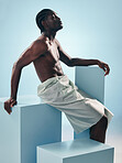 Body, black man and thinking profile in studio with art, skincare and glow from skin wellness and confidence. Strong muscle and African male model with creative blue background and relax with power