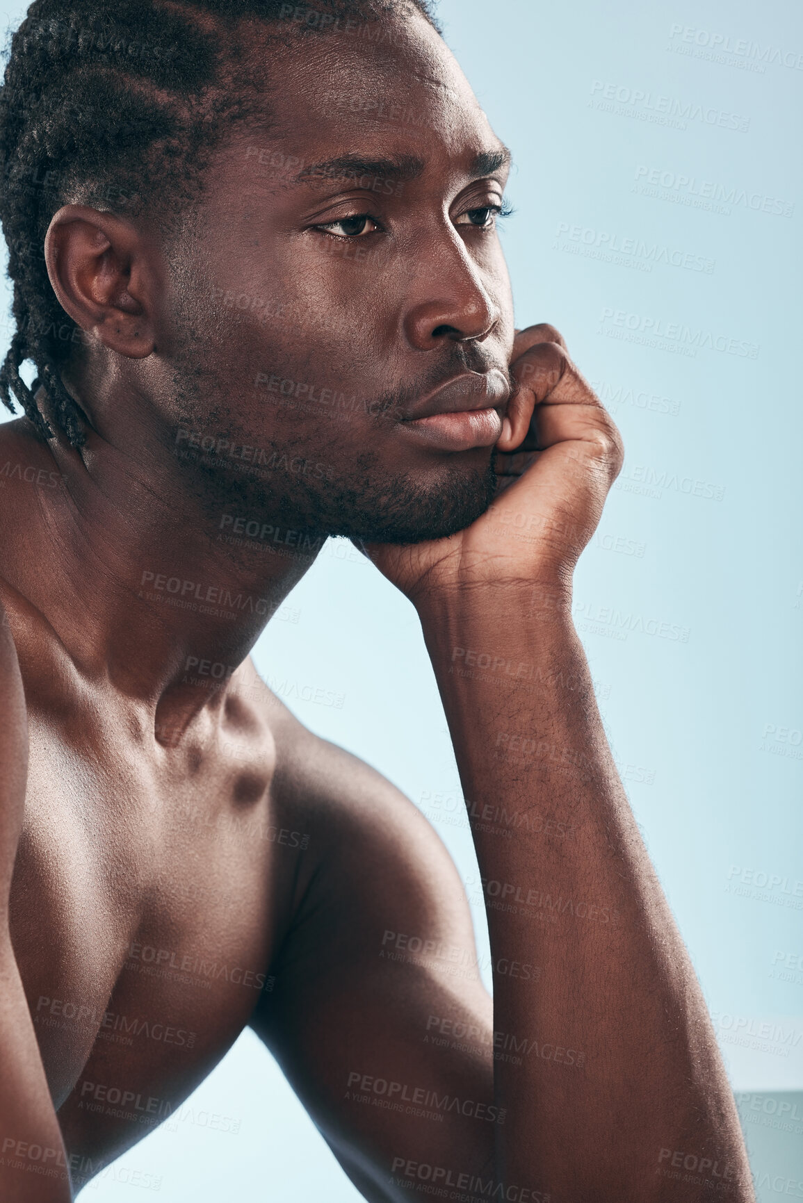 Buy stock photo Thinking, beauty and black man with cometic skincare and smooth aesthetic isolated in a studio blue background. Care, dermatology and young shirtless person with natural calm, relax and skin