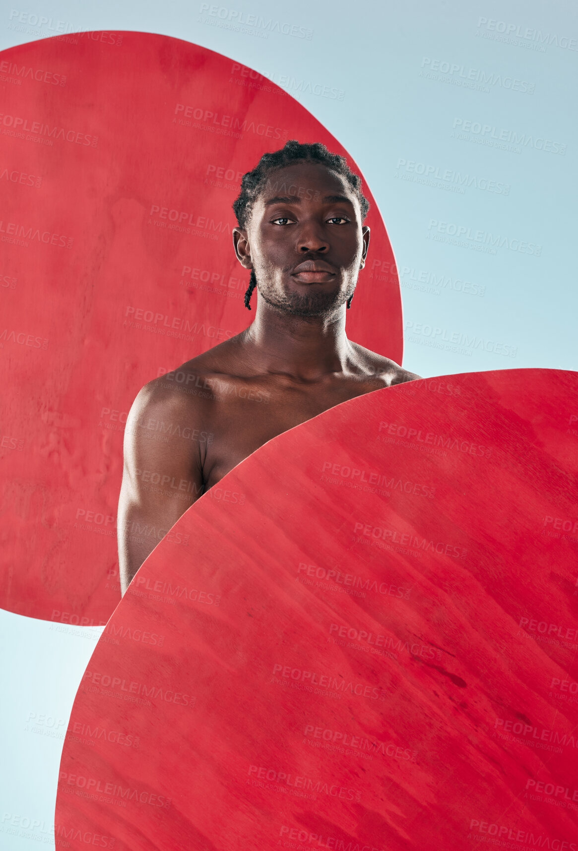 Buy stock photo Portrait, black man and muscle with creativity, fitness and artistic on a blue studio background. Face, African person and model with red circle, art and exercise with aesthetic, proud and mockup