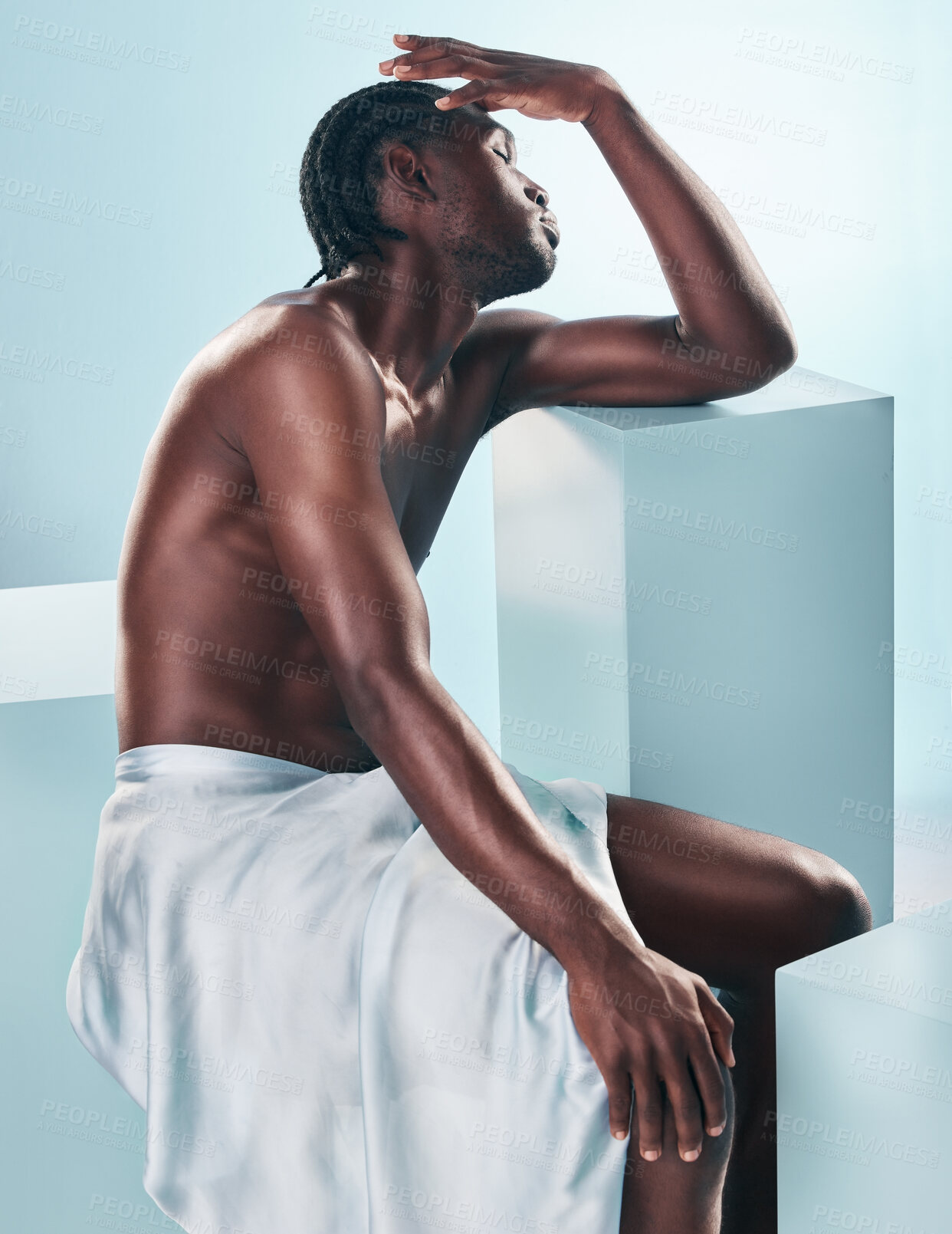 Buy stock photo Body, black man and beauty of art and thinking profile in studio with skincare and glow from wellness and towel. Strong muscle and African model with creative blue background and relax with fitness