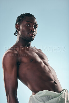 Buy stock photo Body, black man and portrait in studio with art, skincare and glow from skin wellness and fitness confidence. Strong muscle and African male model with creative blue background and relax with power