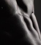 Fitness, black man and torso and closeup in studio for wellness, stomach and body on dark background. Person, muscle and six pack with bodybuilder or guy and strength, topless and body or abdomen
