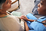 Counseling, empathy and help, caregiver and patient at retirement home for elderly care and support. Women sitting together holding hands, wellness and advice with kindness and respect with trust