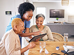 Tablet, smile and an assisted living nurse with old people in the kitchen of a retirement home for consulting. Technology, medical and an african caregiver showing information to woman friends