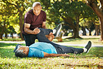 Stretching, park and men for fitness physiotherapy, support or help with exercise. Wellness, training and senior coach with an elderly athlete for a warm up on the grass for sports or rehabilitation