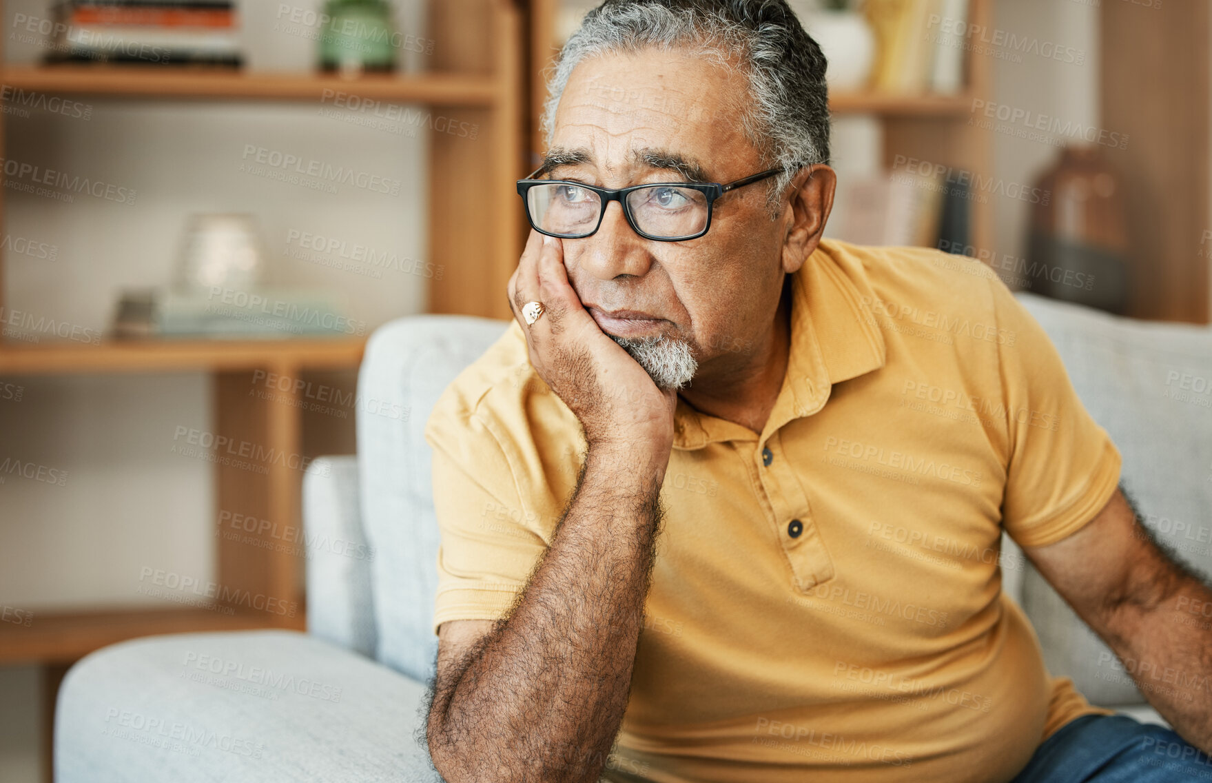 Buy stock photo Face, depression and dementia with a sad old man on a sofa in the living room of his retirement home. Mental health, thinking or alzheimer and a senior person looking lonely with memory nostalgia