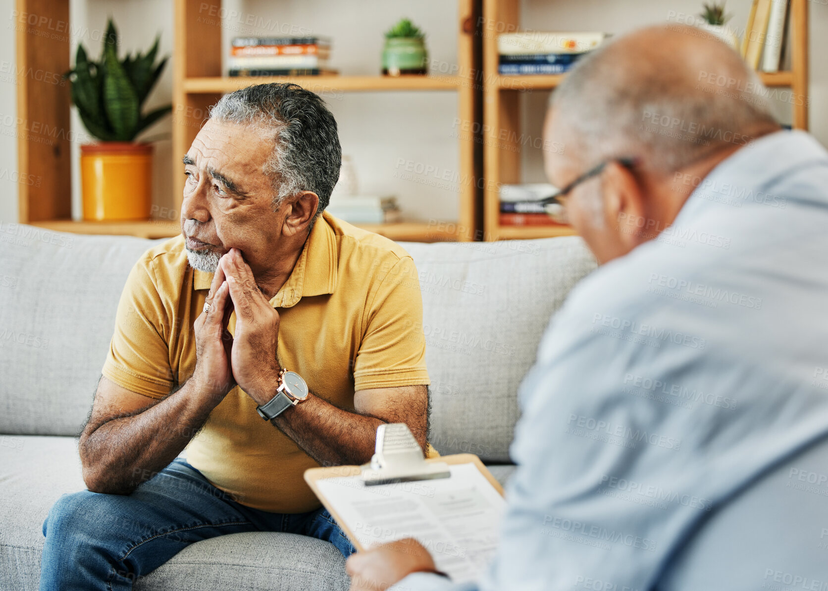 Buy stock photo Sad senior man talking to psychologist at mental health, psychology and therapy clinic for session. Psychological therapist with clipboard for counseling checklist with elderly male patient in office