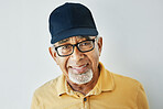 Elderly man, hat and glasses with modern style, casual and trendy fashion in studio with smile. Happy indian man, retired and model with contemporary clothes in closeup by grey isolated background 