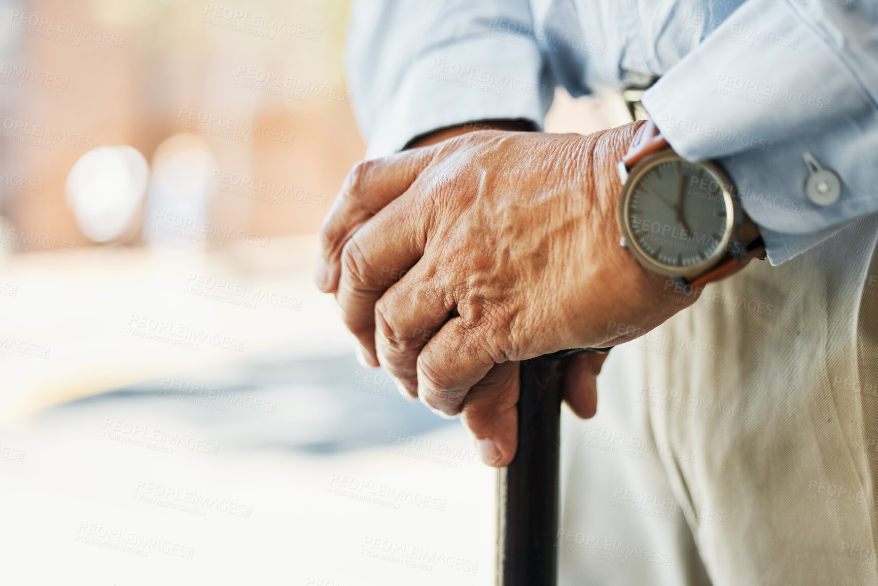 Buy stock photo Senior, hands and stand with cane in closeup for retirement, vacation or trip on blurred background. Elderly, person and wrinkles with health, medical care or wellness in rehabilitation for injury