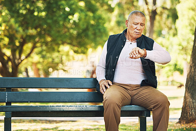 Buy stock photo Check, watch and senior man outdoor in nature, park or planning activity in retirement schedule. Reading, time and elderly person sitting on bench in woods, environment or forest with technology