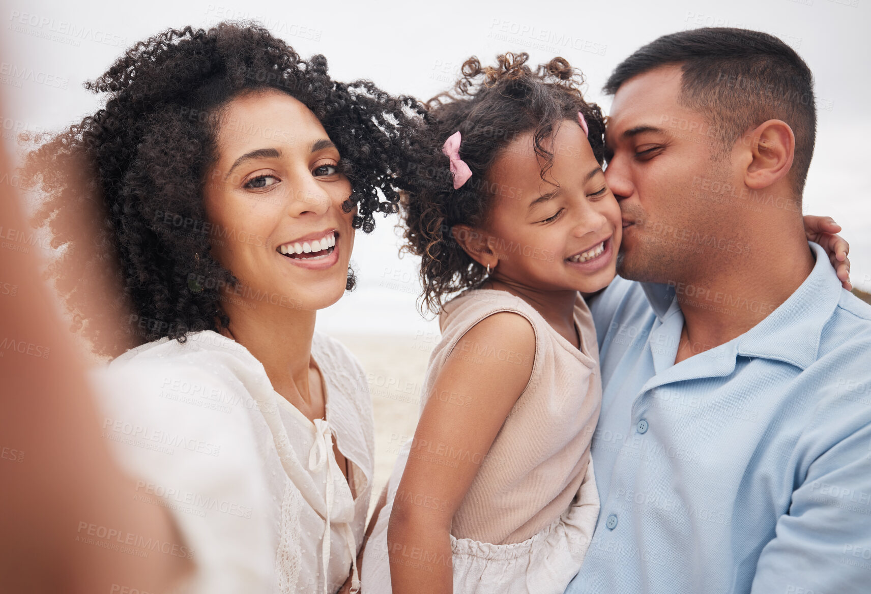 Buy stock photo Selfie, portrait and a family at the beach with a kiss, bonding or fun on a vacation. Happy, travel and a mother, father and girl kid taking a photo at the ocean for summer freedom, love and care