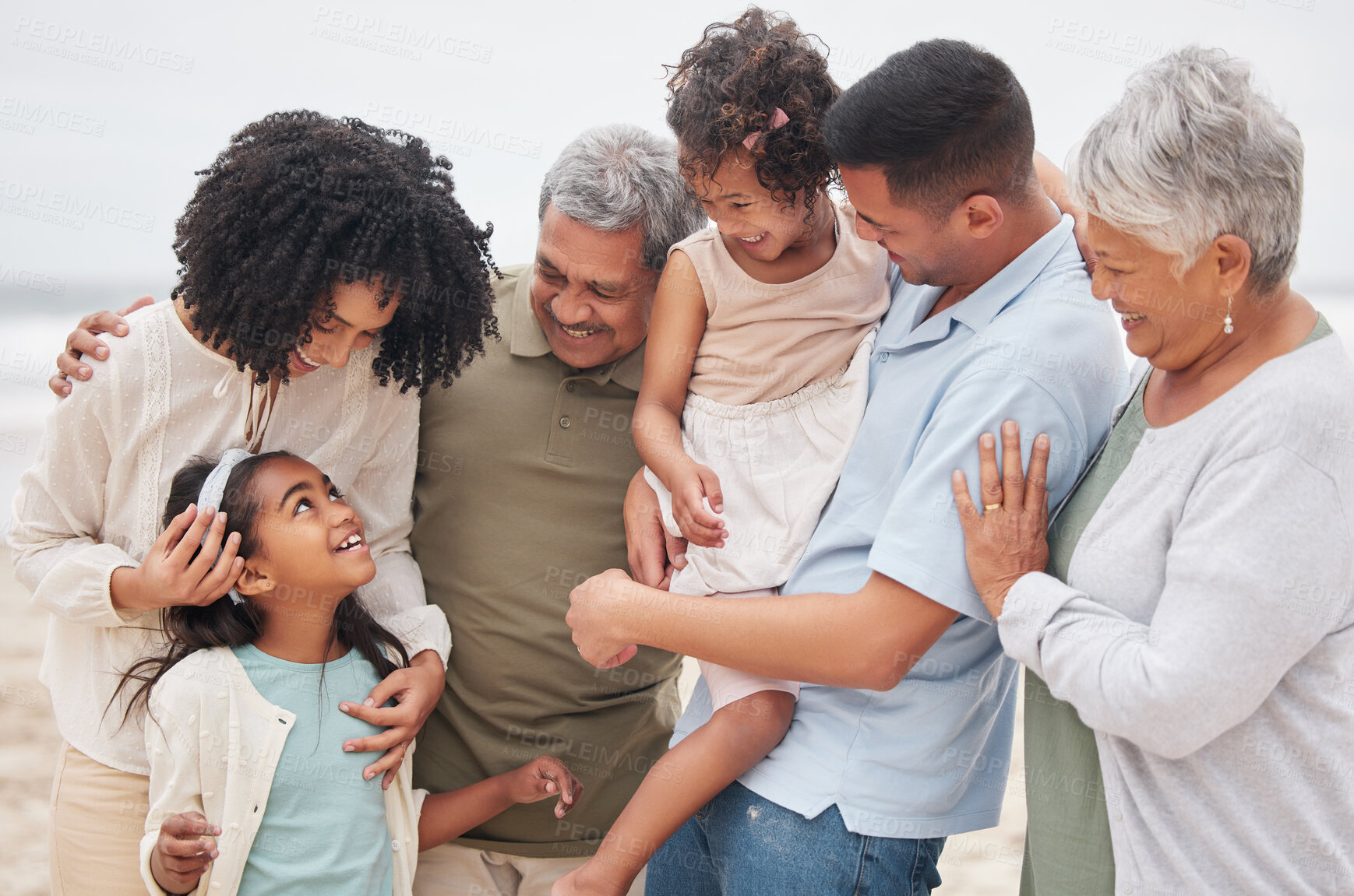 Buy stock photo Beach, big family or happy grandparents with children in nature to enjoy holiday vacation in New Zealand. Travel, hug or proud father at sea or ocean with kids, care or mom to relax or bond together